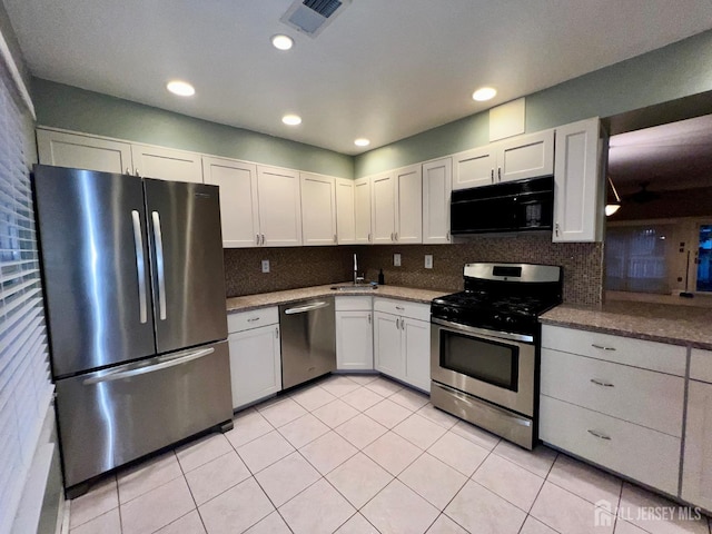 37 Albury Way N, Brunswick, NJ 08902 - kitchen featuring stainless steel appliances, light tile patterned flooring, decorative backsplash, stone counters, and recessed lighting