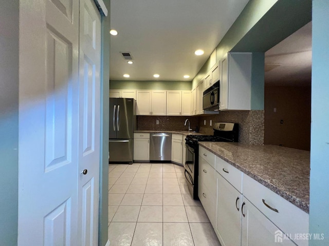 37 Albury Way N, Brunswick, NJ 08902 - kitchen with stainless steel appliances, light tile patterned floors, decorative backsplash, white cabinetry, and recessed lighting