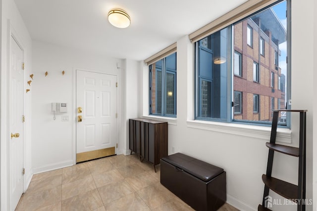 entryway featuring baseboards