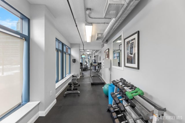 exercise room featuring baseboards