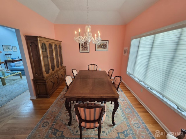 16 Phillip Ct, Monroe, NJ 08831 - dining space featuring a chandelier, wood finished floors, and vaulted ceiling