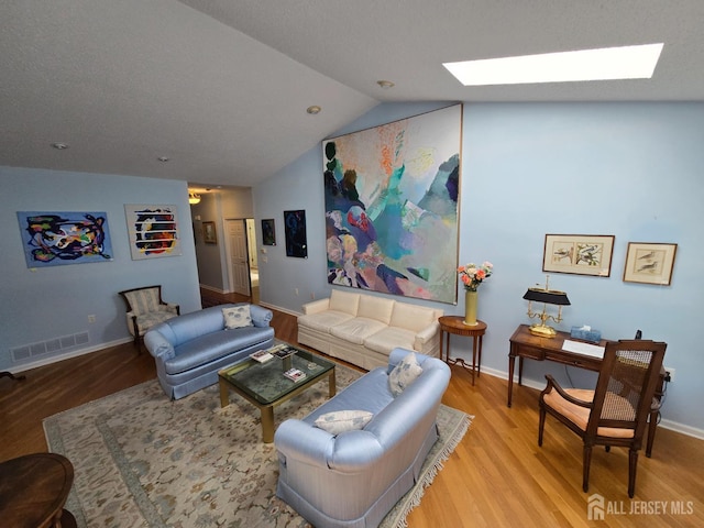 16 Phillip Ct, Monroe, NJ 08831 - living area featuring a skylight, light wood-style floors, vaulted ceiling, and baseboards