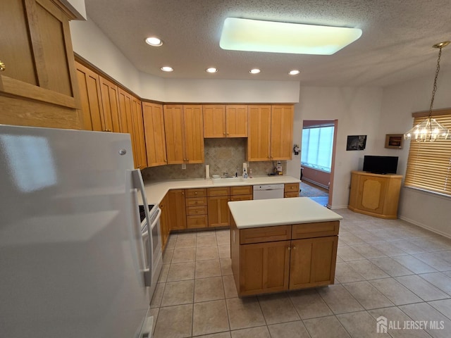 16 Phillip Ct, Monroe, NJ 08831 - kitchen featuring white appliances, backsplash, a kitchen island, light countertops, and light tile patterned floors
