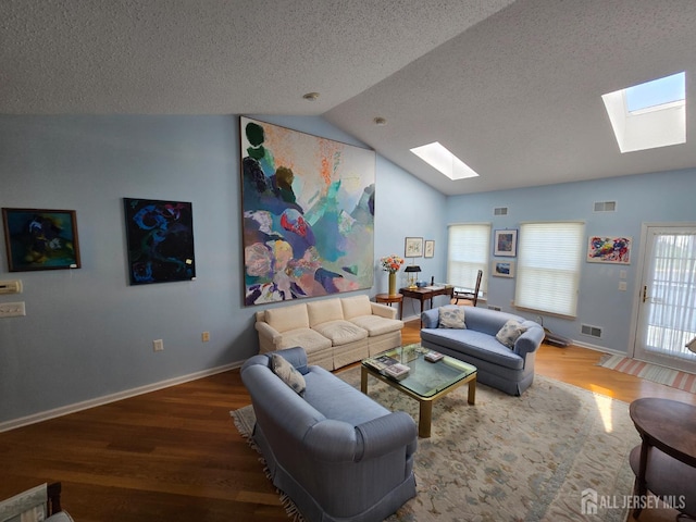 16 Phillip Ct, Monroe, NJ 08831 - living area with a skylight, wood finished floors, lofted ceiling, a textured ceiling, and baseboards