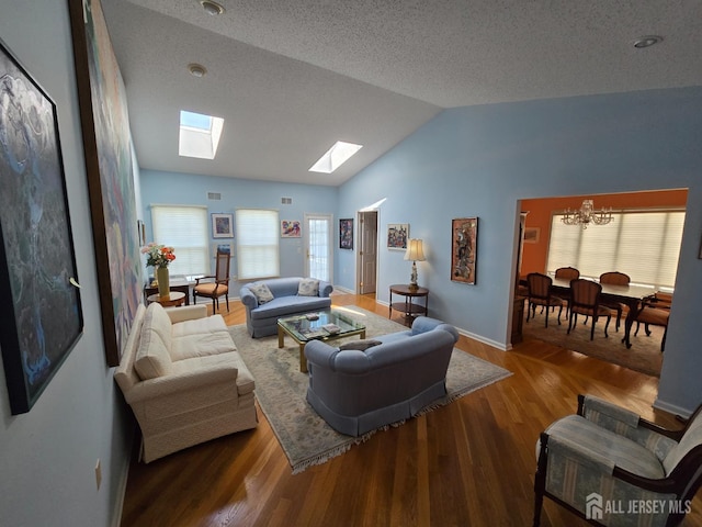 16 Phillip Ct, Monroe, NJ 08831 - living room featuring a skylight, a chandelier, lofted ceiling, wood finished floors, and a textured ceiling