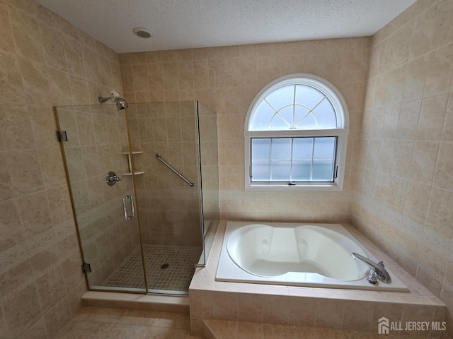 16 Phillip Ct, Monroe, NJ 08831 - bathroom featuring a stall shower, a garden tub, tile patterned flooring, and a textured ceiling