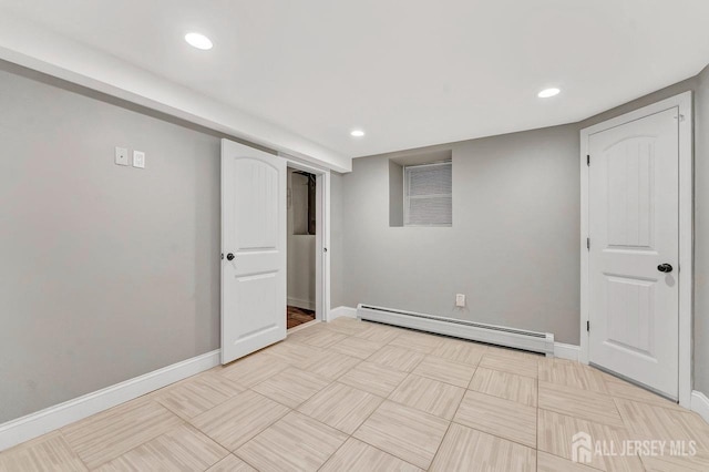 interior space featuring a baseboard heating unit, recessed lighting, and baseboards