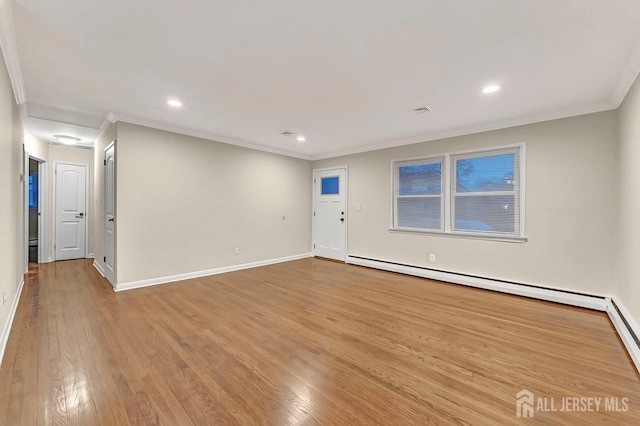 empty room featuring crown molding, recessed lighting, baseboard heating, light wood-type flooring, and baseboards