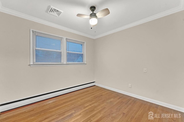 empty room with a baseboard heating unit, visible vents, baseboards, ornamental molding, and light wood finished floors