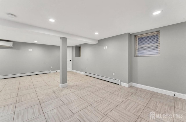 finished basement with a baseboard radiator, baseboards, and a wall mounted AC