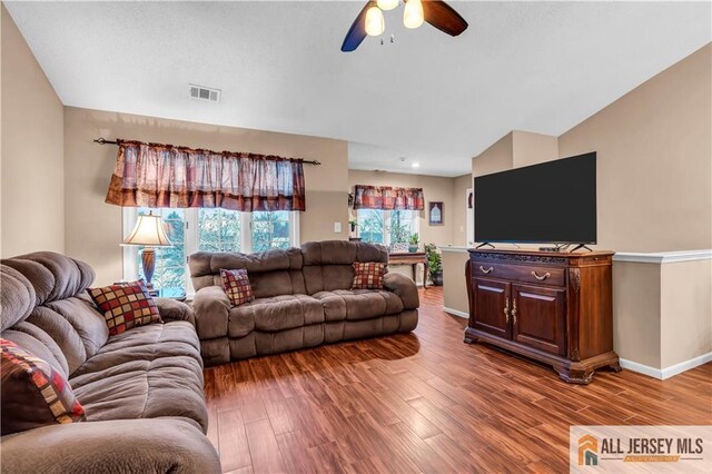 living room featuring ceiling fan and hardwood / wood-style floors