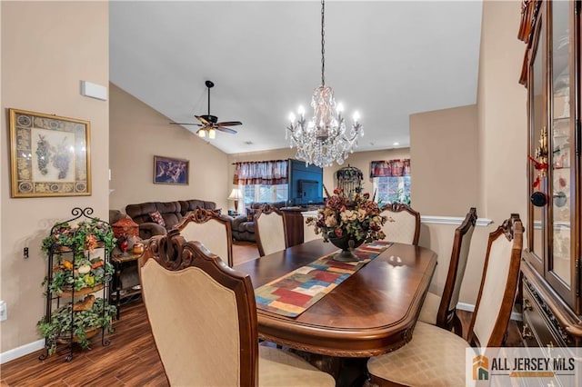 dining area with vaulted ceiling, wood finished floors, a ceiling fan, and baseboards