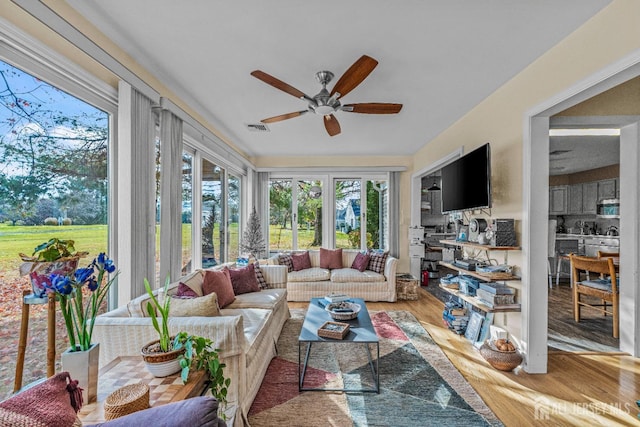 sunroom / solarium featuring ceiling fan