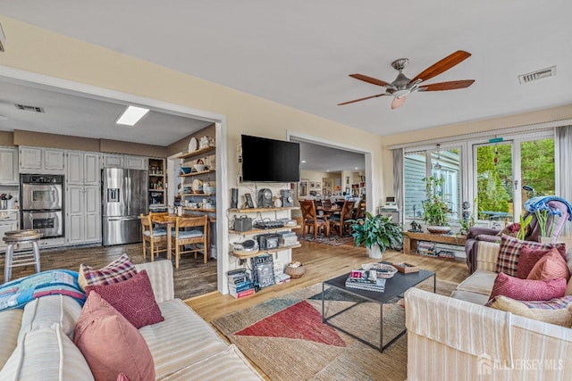 living room featuring hardwood / wood-style flooring and ceiling fan