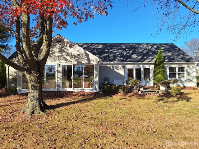 rear view of house with a lawn