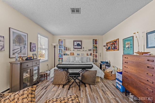 interior space featuring hardwood / wood-style floors and a textured ceiling