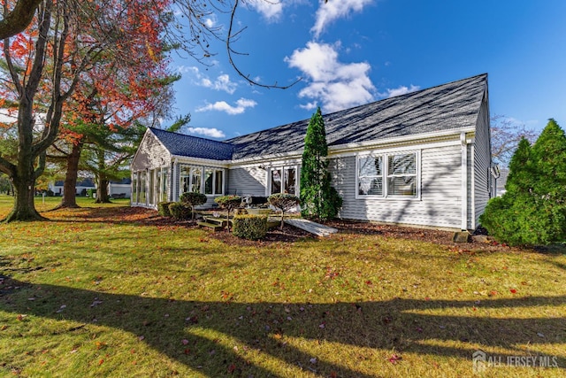 rear view of house with a yard