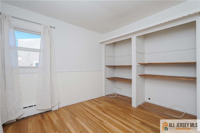 empty room with hardwood / wood-style flooring