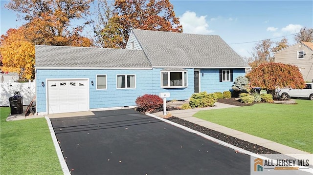 view of front of home featuring a front yard and a garage