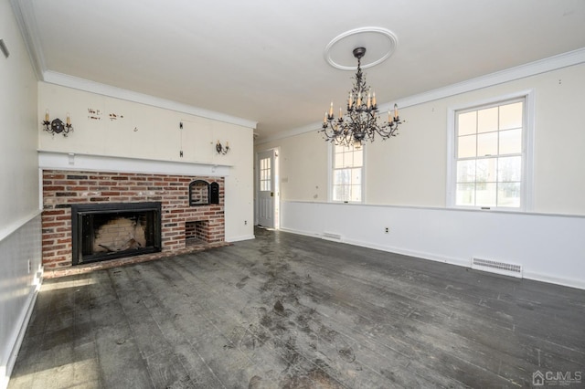 unfurnished living room with visible vents, a fireplace, dark wood finished floors, a chandelier, and ornamental molding
