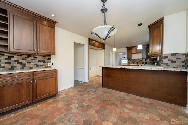 kitchen with open shelves, backsplash, a peninsula, and decorative light fixtures