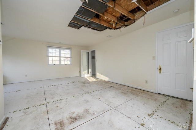 empty room featuring baseboards