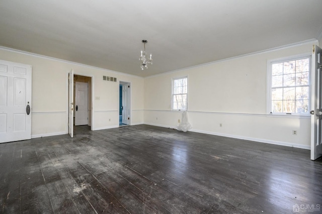 unfurnished living room featuring a notable chandelier, ornamental molding, baseboards, visible vents, and dark wood-style floors