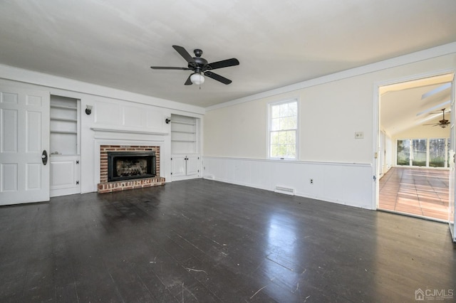 unfurnished living room with visible vents, a brick fireplace, ceiling fan, and built in shelves