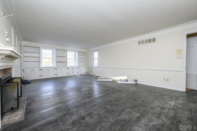 unfurnished living room featuring visible vents, crown molding, a brick fireplace, dark wood finished floors, and baseboards