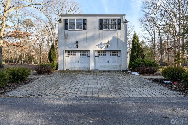garage featuring decorative driveway