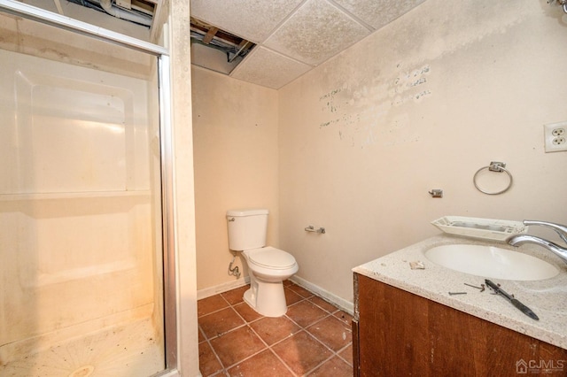 full bathroom featuring tile patterned flooring, vanity, toilet, baseboards, and a shower stall