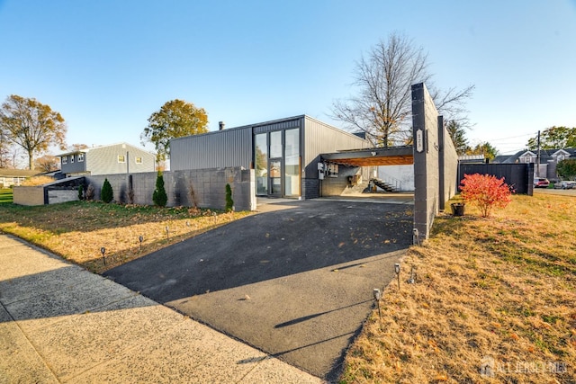 exterior space with a front lawn and a carport