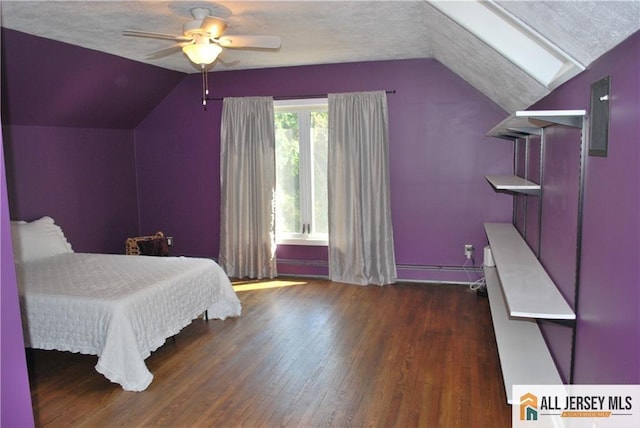 bedroom with ceiling fan, vaulted ceiling, wood finished floors, a textured ceiling, and a baseboard radiator