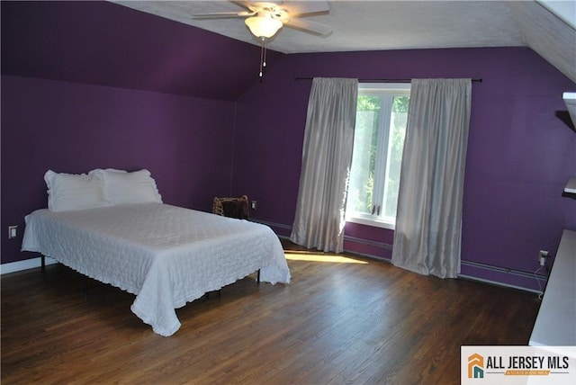 bedroom featuring ceiling fan, a baseboard heating unit, lofted ceiling, and wood finished floors