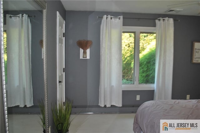 bedroom featuring visible vents and baseboard heating