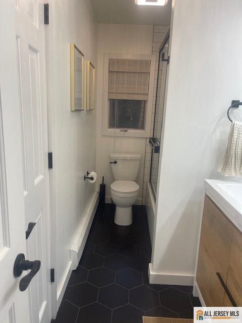 bathroom with tile patterned floors, baseboards, toilet, and vanity