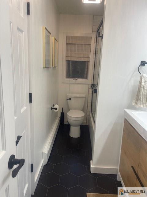 full bath with tile patterned flooring, toilet, vanity, and baseboards