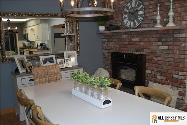 dining area with a fireplace and baseboards