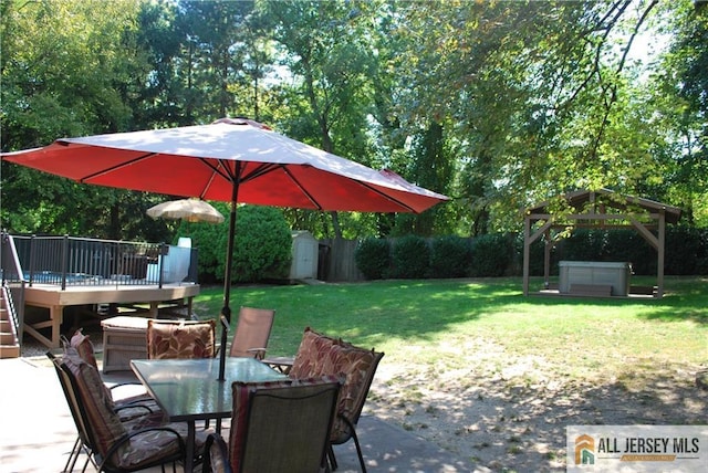 view of patio / terrace with a storage unit, a deck, outdoor dining area, and an outdoor structure