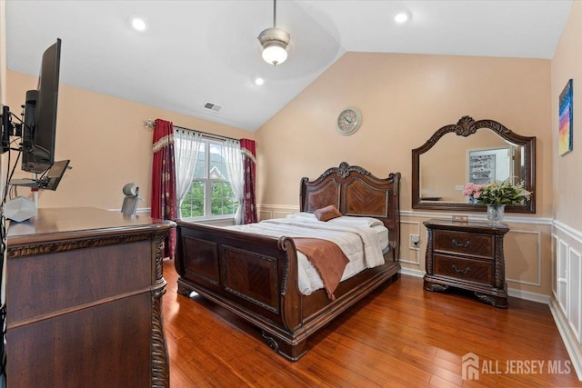 2420 Canterbury Ln, North Brunswick, NJ 08902 - bedroom with vaulted ceiling, wainscoting, wood finished floors, a decorative wall, and an office area