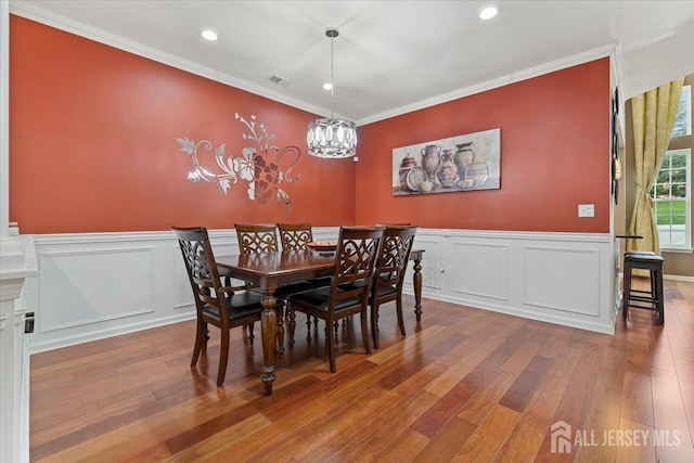 2420 Canterbury Ln, North Brunswick, NJ 08902 - dining room with wood finished floors, crown molding, recessed lighting, a wainscoted wall, and a chandelier