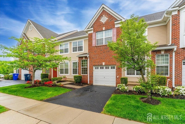 2420 Canterbury Ln, North Brunswick, NJ 08902 - view of property featuring brick siding, an attached garage, driveway, and a front yard