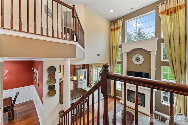 2420 Canterbury Ln, North Brunswick, NJ 08902 - staircase with a towering ceiling, decorative columns, wood finished floors, healthy amount of natural light, and recessed lighting