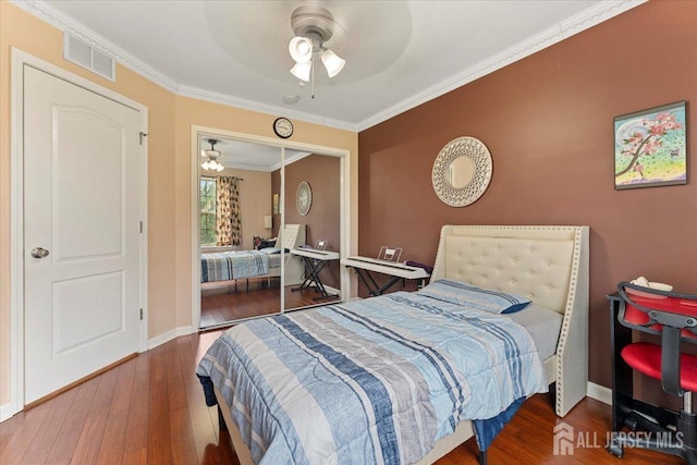 2420 Canterbury Ln, North Brunswick, NJ 08902 - bedroom featuring wood finished floors, ornamental molding, ceiling fan, baseboards, and a closet
