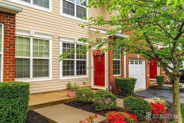 2420 Canterbury Ln, North Brunswick, NJ 08902 - view of exterior entry with brick siding and a garage