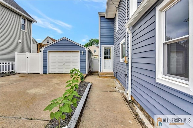 27 Laurel St, South Amboy, NJ 08879 - view of side of home with concrete driveway, an outbuilding, entry steps, and a detached garage