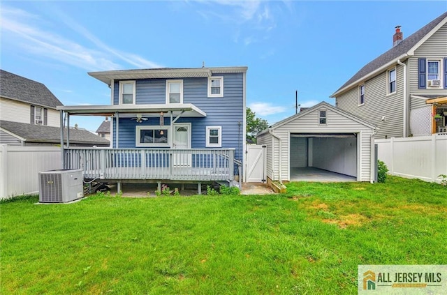 27 Laurel St, South Amboy, NJ 08879 - back of property with a detached garage, a fenced backyard, a deck, and an outbuilding