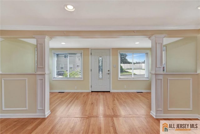 27 Laurel St, South Amboy, NJ 08879 - entryway with decorative columns, light wood-type flooring, and ornamental molding
