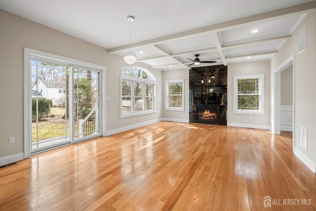 unfurnished living room with light wood-type flooring, baseboards, visible vents, and coffered ceiling