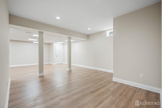 below grade area featuring recessed lighting, light wood-style floors, and baseboards